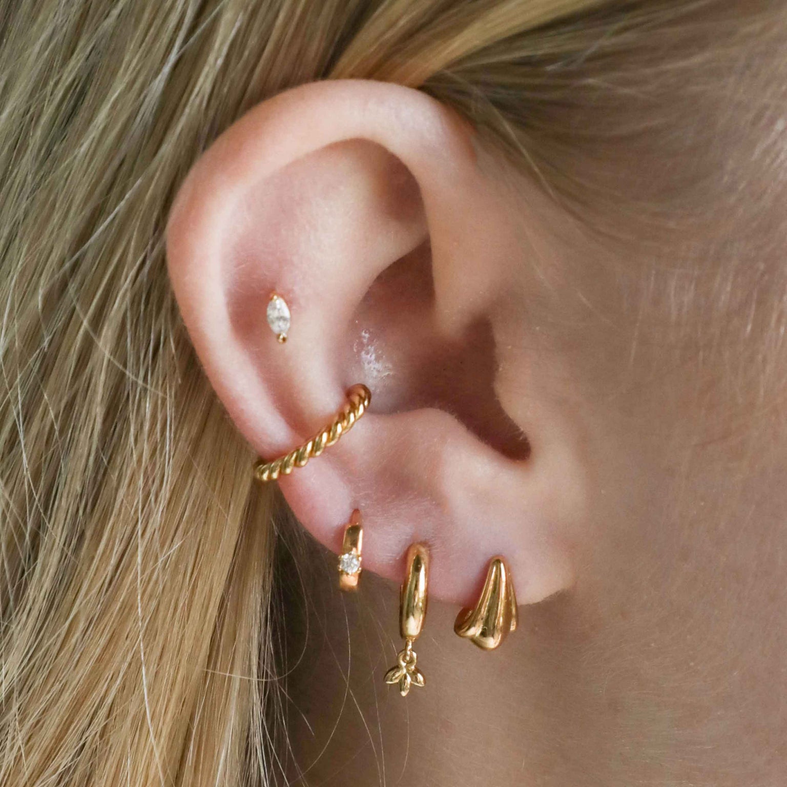 Navette Stud Earrings in Gold worn in outer conch